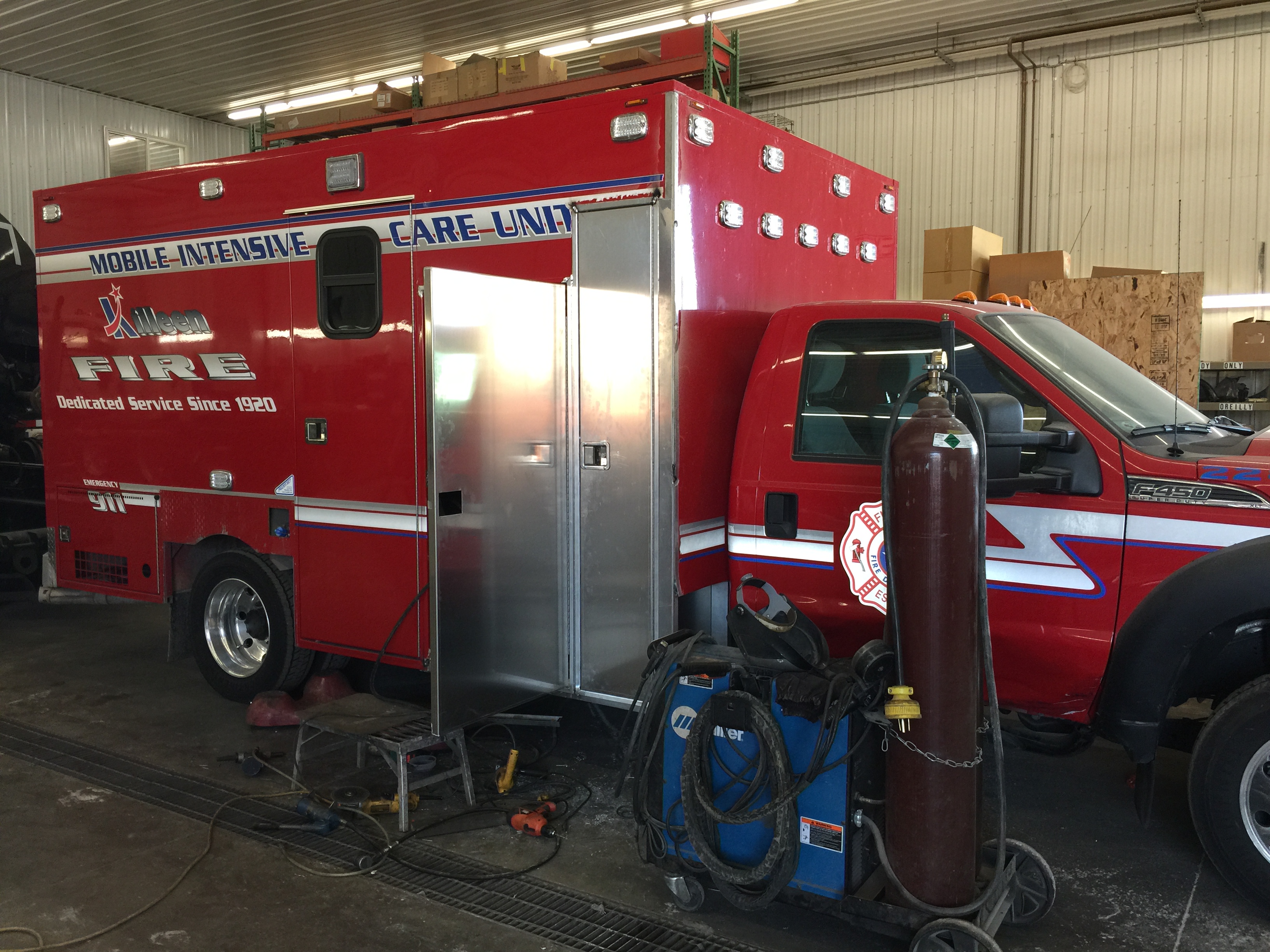 Red ambulance emergency vehicle in service facility