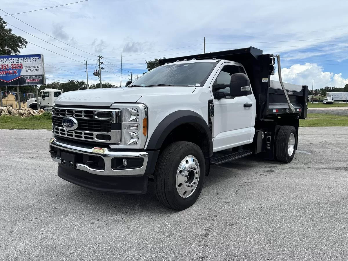 White upfitted flatbed dump truck