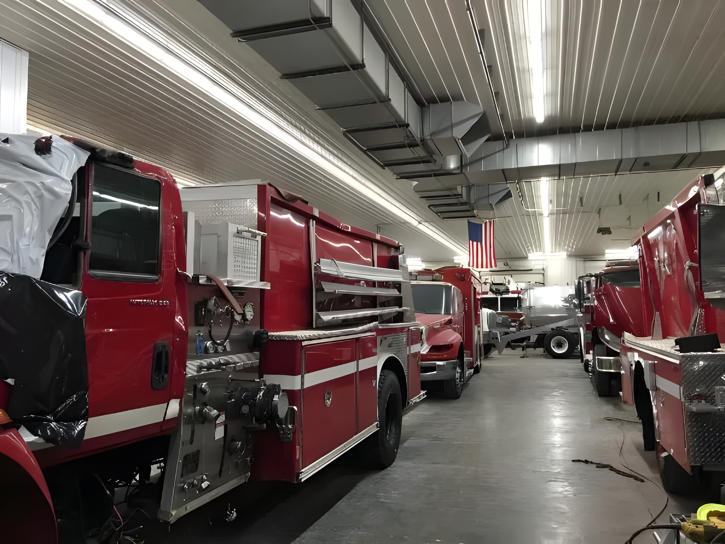 Fire trucks inside commercial truck body shop