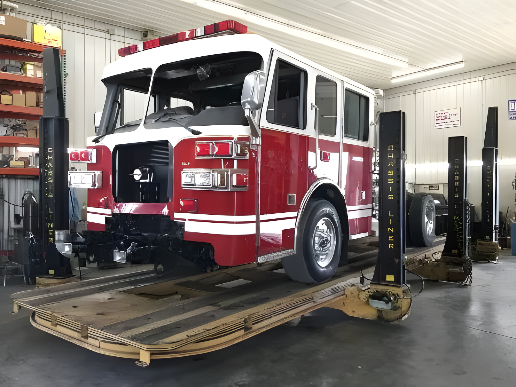 Fire truck on lift in commercial truck body shop