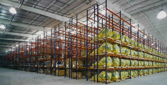 Rows of pallet racking loaded with stock in a large warehouse