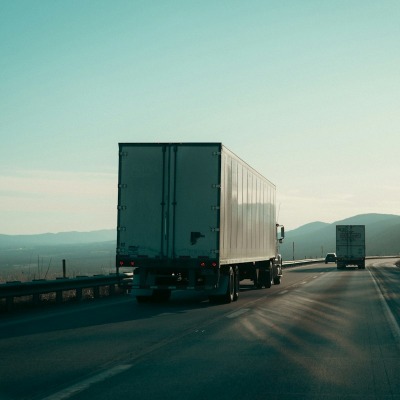 Semi trucks hauling trailers on a highway